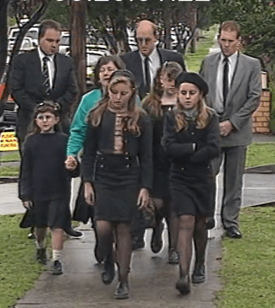 The Wills family are escorted to Karmein Chan's funeral service at Bulleen Baptist Church by 2 unnamed police detectives. Sharon Wills is pictured to the right of her mother Julie.